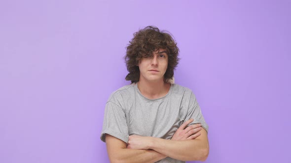 A Young Guy with Curly Hair Smiles at the Camera on an Isolated Background a Pet Rat is Sitting on