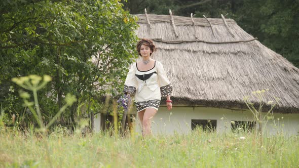 Girl walking near an old house