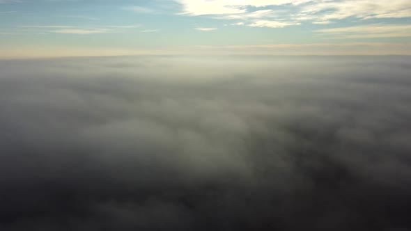 Aerial Drone View Flight Over Above Fog Mist and Roofs of Buildings in City