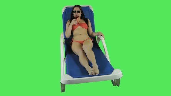 Female relaxing on sun bed
