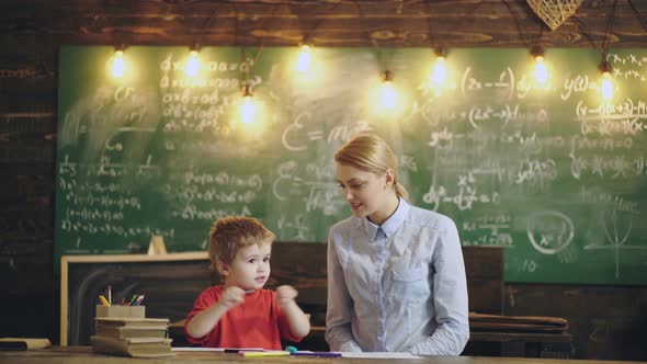 Elementary School and Preschool Kid. Overjoyed Young Mother and Small Preschooler Son Playing 