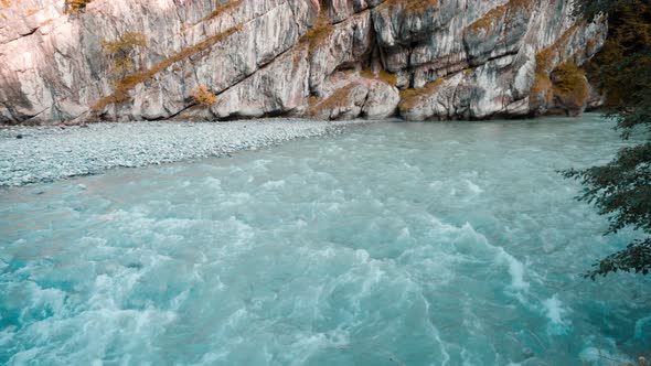 The River Flows Along the Cliffs