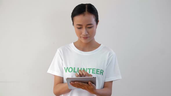 Asian Volunteer Using Tablet