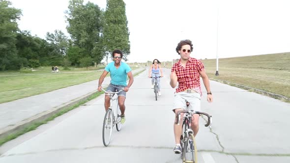 Three young adults having fun cycling