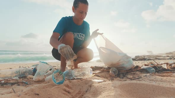 Young Woman Volunteer to Clean Beach of Rubbish and Plastic Bottles
