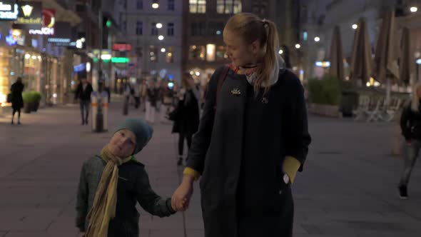 Mother and Child Walking in Shopping Street of Vienna, Austria