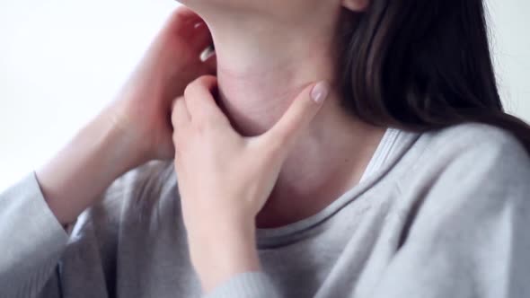 Woman with Allergy Scratching Neck