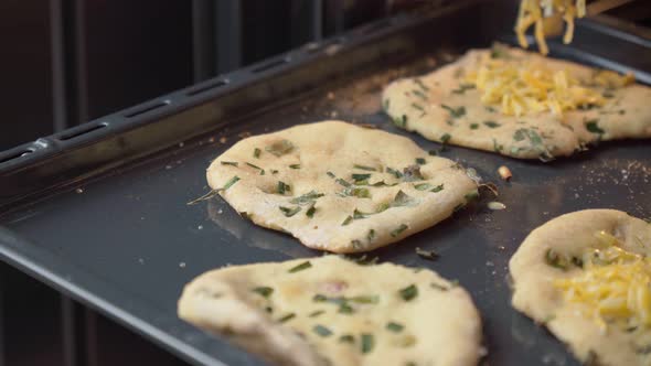 Mini Pizzas in the Oven on a Baking Sheet Before Cooking