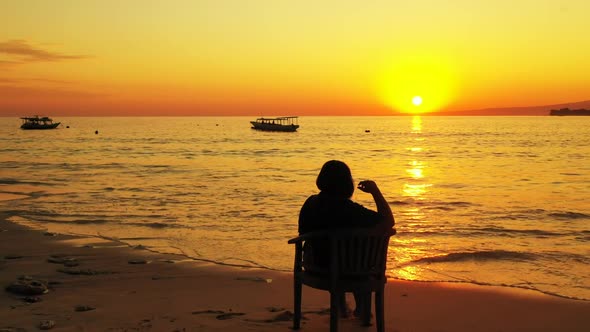 Single lady suntans on beautiful lagoon beach wildlife by blue water and white sandy background of t