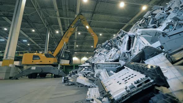 Landfill Unit with Plastic Waste and an Excavator