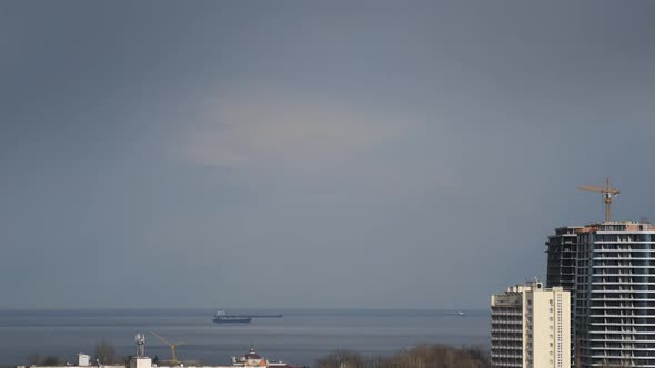 Urban Skyline Time Lapse with Overcast Clouds Over Sea Shore and Vessels Sailing