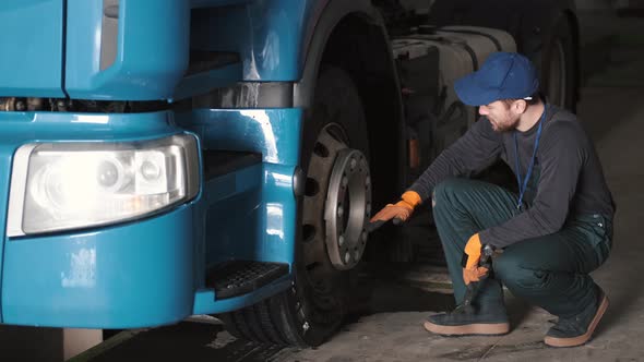 Car Mechanic Repairing Truck Tyres at Car Service