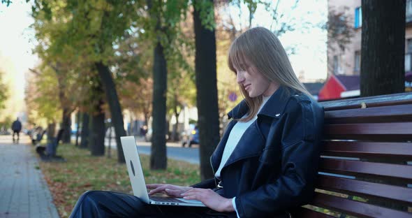 Female Student with Laptop in Park
