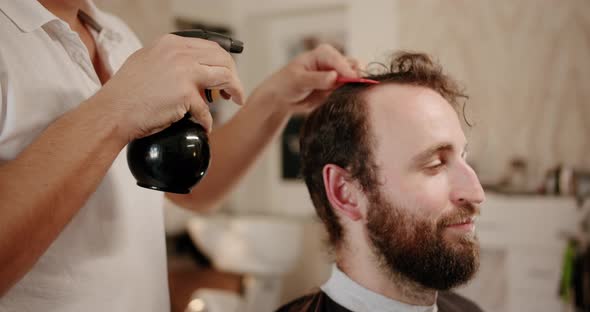 Barber Sets Hair By Spray and Combs Them