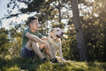 Man with his dog resting in grass under tree - PhotoDune Item for Sale