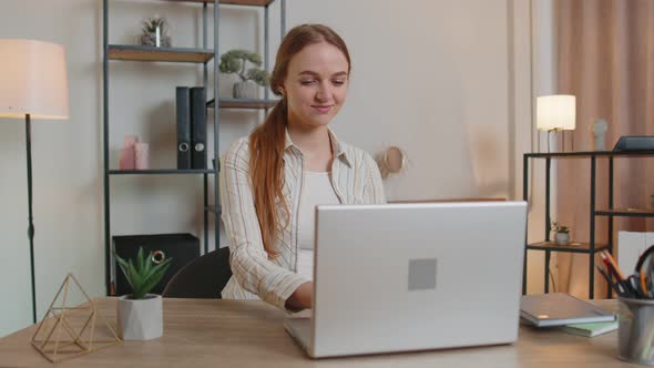 Caucasian Young Woman Sitting at Table Opening Laptop Pc Starting Work Online in Room at Home Office