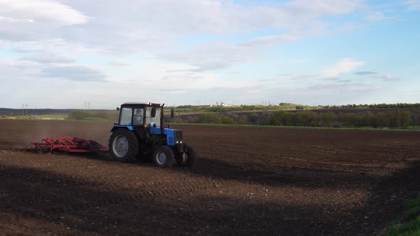 Tractor plows the farm field