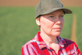 Headshot portrait of female farmer in cultivated wheat seedling field - PhotoDune Item for Sale