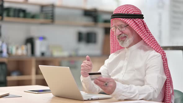 Senior Old Arab Businessman with Successful Online Payment on Laptop 