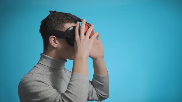 Surprised Guy Enjoys Virtual Reality Using Orange Headset