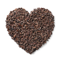 Cacao nibs in heart shape on white background close up - PhotoDune Item for Sale