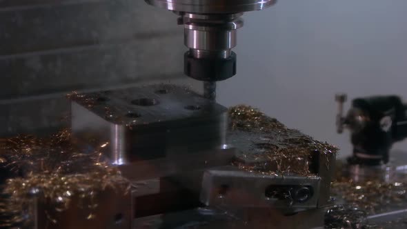 Closeup of Idle Drill Machine and Many Metallic Shavings