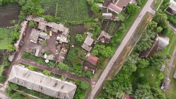 Flying over village with small houses in summer