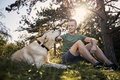 Man with his dog resting in grass under tree - PhotoDune Item for Sale