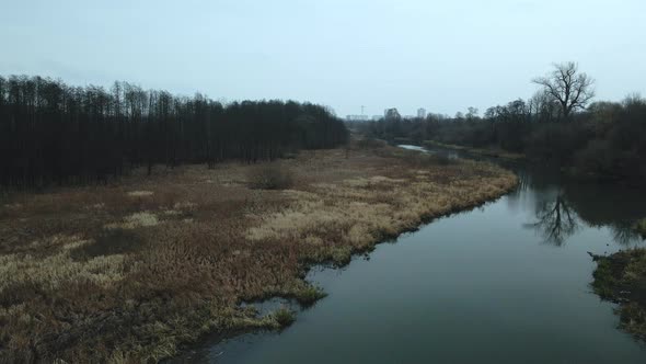 The river among the city park. Late autumn, cloudy.