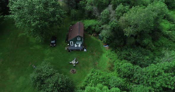 A high zoom reveal of a small secluded cabin off the grid in the Catskill Mountains New York.