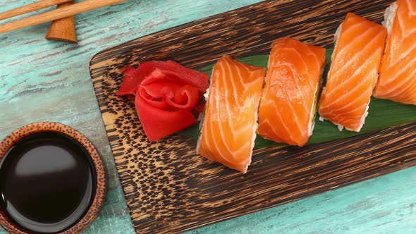 Set of salmon sushi rolls on table