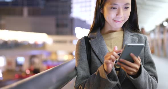 Woman use of cellphone at night