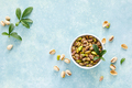Pistachios. Whole pistachios with green leaves and pistachio nut kernels - PhotoDune Item for Sale