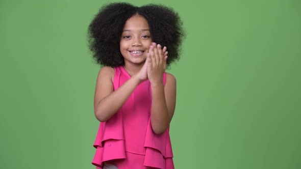 Young Happy African Girl with Afro Hair Clapping Hands