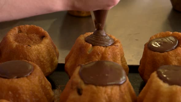 Close Up Chef Decorating Rum Baba with Cream