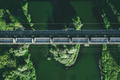 Aerial view of Railway railroad tracks and cargo train over the river - PhotoDune Item for Sale
