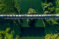 Aerial view of Railway railroad tracks and cargo train over the river - PhotoDune Item for Sale