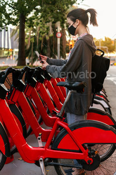 k scanning the code with a smart phone to unlock a bike from the urban bike rental parking, concept of active lifestyle and sustainable mobility