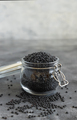 Glass jar of dry black lentils beans on grey table close up,  healthy protein diet - PhotoDune Item for Sale