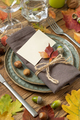 Autumn rustic table setting with place card between colorful leaves and berries close up, mockup - PhotoDune Item for Sale
