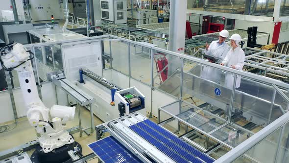 Solar Panel Production Process with Two Inspectors Observing It