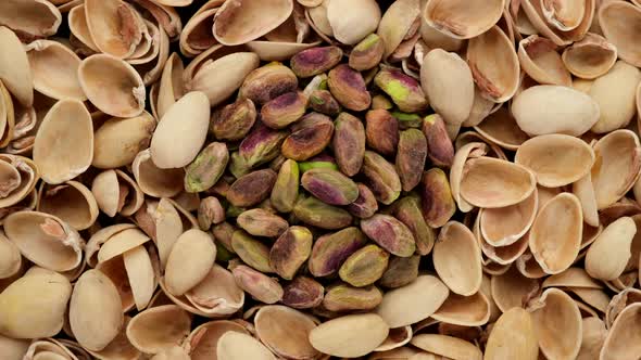 Pistachio nuts and husks top view, rotation