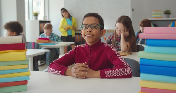 Portrait of African Schoolboy at Desk in School Class