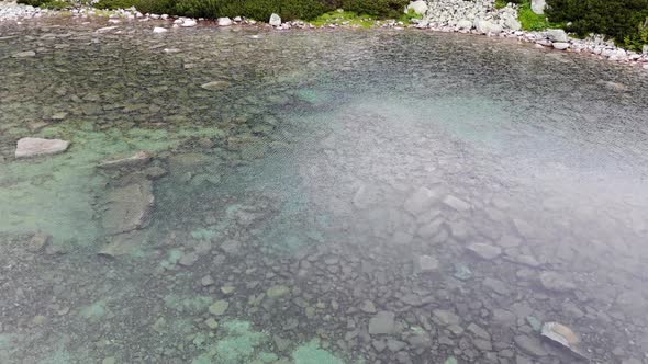 AERIAL: Mountain Lake with Clear Turquoise Water