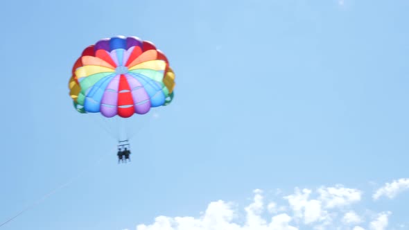 Couple Parasailing and Getting Up in the Sky