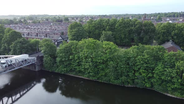 Aerial view Manchester ship canal swing bridge trees Warrington England revealing countryside houses
