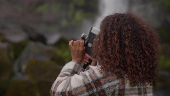 Woman Using Old Camera To Film By Oxararfoss Waterfall