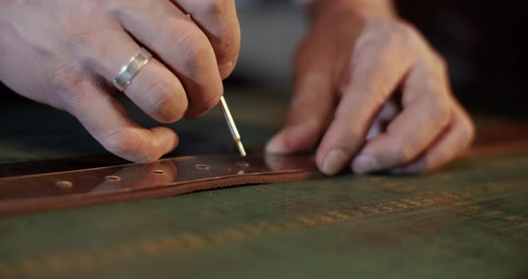 Cropped Artisan Marking Holes on Belt