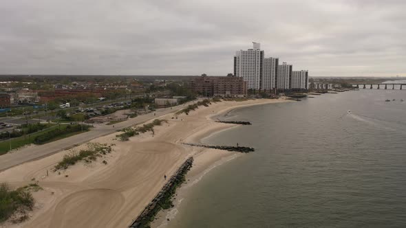 An aerial shot over the East Rockaway Inlet in NY. The drone dolly in to the Nassau Expressway, to t