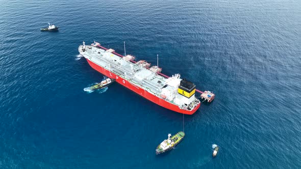 Tugs help the gas tanker to go to sea aerial view 4 K Turkey Alanya